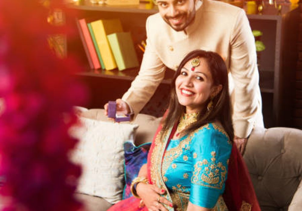 Indian man giving surprise gift to wife, jewellery on Diwali or Wedding anniversary, selective focus
