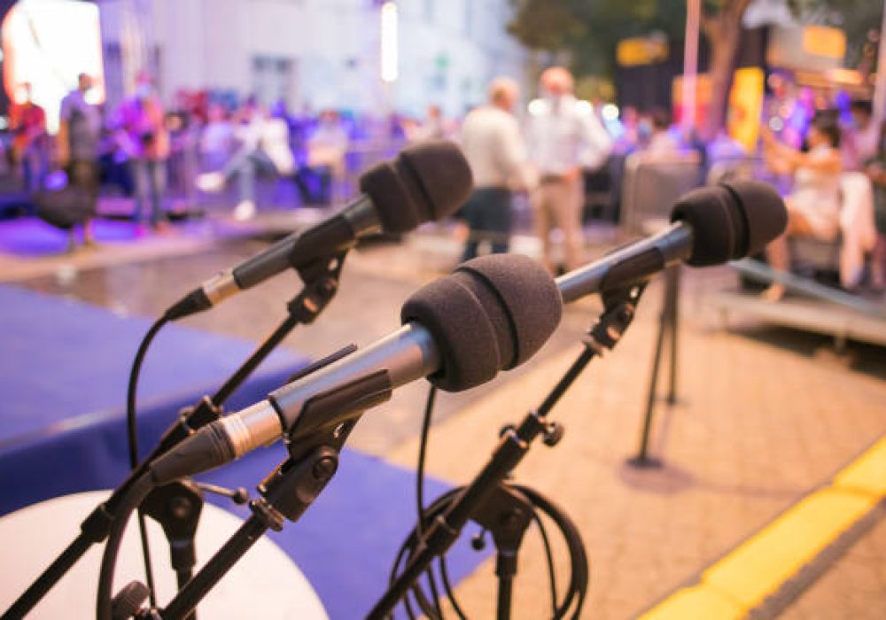 three microphones ready at a seminar event